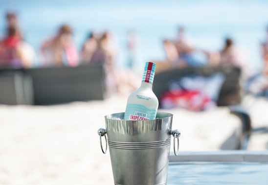 Bottle of Liqueur Tropézienne in an ice bucket at a beach club on the Plage Pampelonne