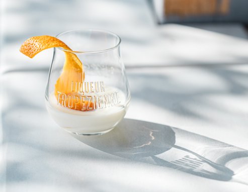 Best Serve Liqueur Tropézienne with orange peel in the sunshine